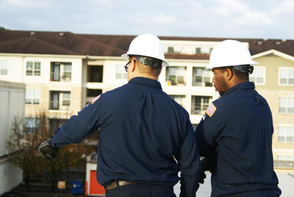HVAC facility technicians inspecting commercial building HVAC systems for maintenance planning